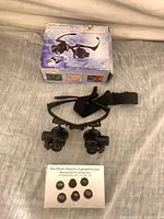 Headband magnifier, four lens sets and box arranged together