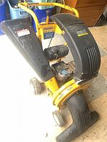 Full view of Cub Cadet chipper-shredder vacuum showing intake chute and front wheels