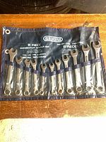 Full view of 11 combination wrenches in blue Gedore roll pouch