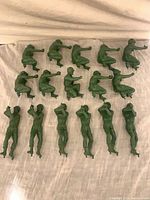 Full set of 16 green plastic toy soldiers arranged in rows