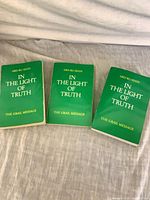 Three green softcover books titled In the Light of Truth