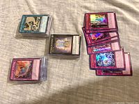 Four stacks of sleeved Yu-Gi-Oh! cards including foil Trap, Spell, Monster and Extra Deck cards