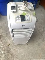 Oblique view of LG portable air conditioner showing remote, power cord and control panel