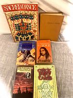 All six books laid out showing front covers and bindings