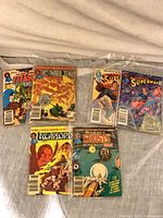 Six DC comic books in two rows, bagged