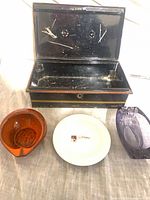 All four items: painted box, orange ceramic ashtray, white Vittorio ashtray, purple glass ashtray