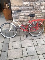 Full side view of cream and red Schwinn step-through bicycle