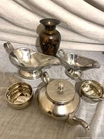 All six pieces grouped together: teapot, two gravy boats, two measuring cups and vase