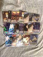 Front view of 20+ cards showing mix of holofoil and standard Avatar Weiss Schwarz cards