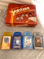 Front view of Yahtzee box with four Top Trumps decks aligned below
