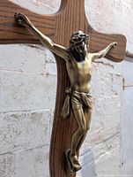 close view brass corpus on oak cross
