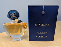 Front view of Shalimar bottle and box showing branding, fill level, cap detail