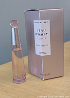 Front view of bottle and box showing product name and size