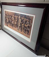 Oblique view of framed print showing frame, matting, and artwork