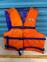 Front view of Buoy-Boy life jacket showing buckles and logo