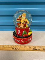 Front view showing Santa figure inside globe and decorated base