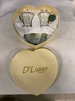 Heart-shaped gift box with lid and contents visible