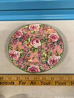 Front of plate showing full floral pattern and approximate size against ruler