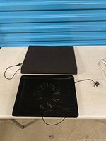 Both items on table: cooling pad with fan and separate stand