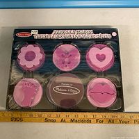 Front of sealed box showing all stampers and ink pad