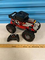 Monster truck with controller front view, ruler for scale