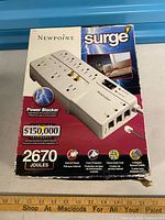 Front of retail box showing Newpoint surge protector image and 2670 joule rating