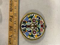 Front view of plate showing full design and ruler for scale