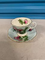 Teacup on saucer showing pattern, shape and colour