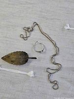 Overview of three jewelry pieces on fabric background