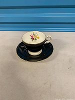 Teacup on matching saucer, full view