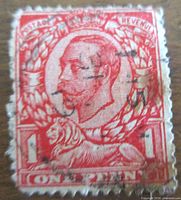 Front of red One Penny stamp with King George V portrait and cancellation
