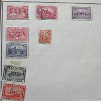 Full album page showing eight Canadian stamps in situ