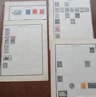 Four album pages laid out on table