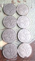 Eight Canada 5-cent coins reverse side showing years and maple leaf design