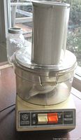 Front view of General Electric food processor showing control panel and feed chute