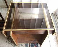 Top view showing smoked glass surface and brass trimmed wooden frame