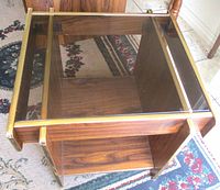 overhead view showing glass top, brass trim, wood veneer