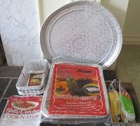 Group shot of round foil pan, Titan Foil package, Betty Crocker package, loaf pans, corn holders
