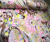 Rolled fabric showing full-width floral print, vivid colors