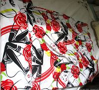 Full view of fabric spread out showing art-deco lady and rose pattern