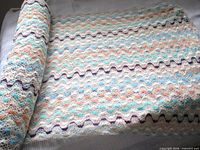 Roll of white mesh fabric displaying overall pattern and length