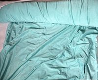 Roll of pale aqua suede-like fabric showing overall quantity