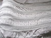 Full view of folded length showing continuous lace and ribbed bands