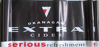 Close-up of single banner showing Okanagan Extra Cider logo and part of slogan