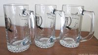 Three Quinte Craft glass beer mugs side view