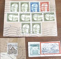 Group of Heuss portrait stamps and additional denominations on envelope piece