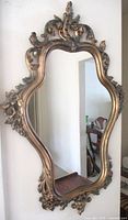 Full view of ornate gold Syroco wall mirror