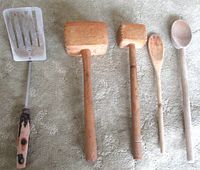 Five utensils laid out: spatula, two mallets, two spoons