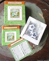 Full kit showing box, booklet, dice in plastic bag, reference card