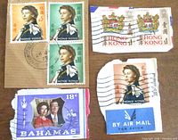 Group shot showing all seven stamps on paper fragments